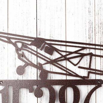 Close up of airplane silhouette on our metal house number sign, in copper vein powder coat. 