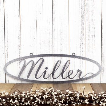 Oval family last name metal sign with script font, in silver vein powder coat.