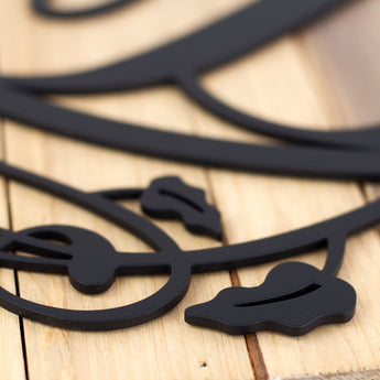 Close up of matte black powder coat on our metal monogram sign.