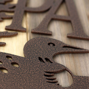 Close up of copper vein powder coat on our rectangular family name sign with loon silhouette. 