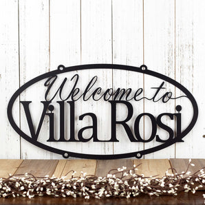 Hanging oval welcome home name metal sign, in matte black powder coat.