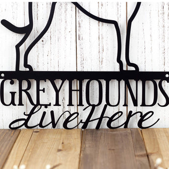 Close up of Greyhounds Live Here wording on our Greyhound dog metal sign, in matte black powder coat.