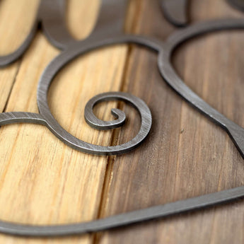 Close up of raw steel on our family metal wall art with hearts. 