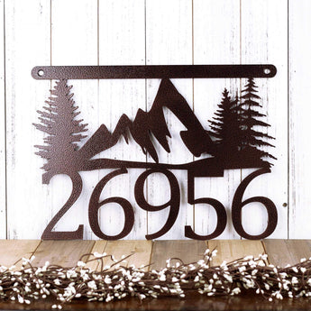 Hanging 5 digit metal house number sign with mountains and pine trees, in copper vein powder coat.