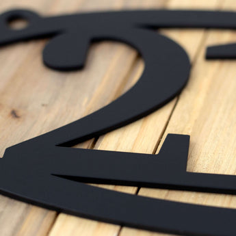 Close up of matte black powder coat on our house number metal sign.