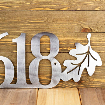 Close up of oak leaf on our 5 digit metal house number sign, in raw steel.