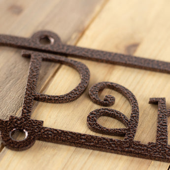 Close up of copper vein powder coat on our metal child name sign. 