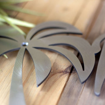 Close up of raw steel on our personalized metal name plaque with palm trees. 