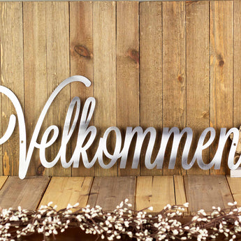 Velkommen welcome metal sign with cursive lettering, in raw steel. 