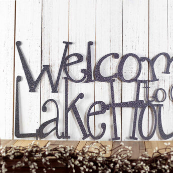 Close up of wording on our metal Welcome to our Lake House sign, in silver vein powder coat. 
