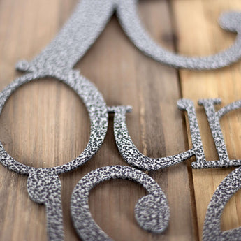 Close up of silver vein powder coat on our Welcome to Our Lake House metal sign.