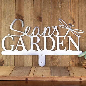 Personalized metal garden sign with first name and dragonfly image, in raw steel.