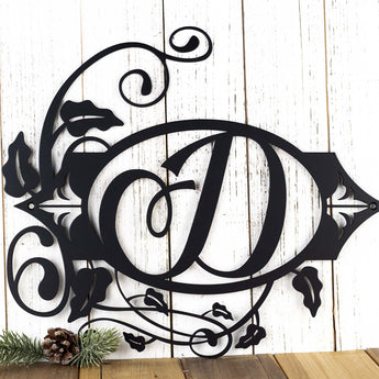 Close up of our metal monogram sign with vines and fleur de lis, in matte black powder coat.