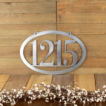 Horizontal oval 4 digit metal house number plaque, in raw steel.