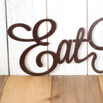 Close up of script lettering on our Eat Pray Love metal wall art, in copper vein powder coat.