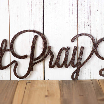 Close up of script lettering on our Eat Pray Love metal sign, in copper vein powder coat.