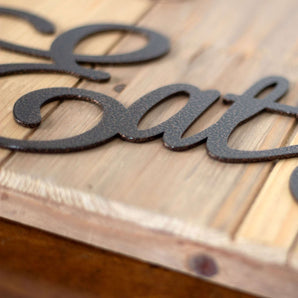Close up of copper vein powder coat on our Eat Pray Love metal sign.