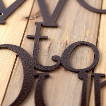Close up of copper vein powde coat on our Welcome to our Cabin metal sign.
