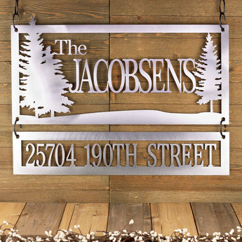 Personalized rectangular family name and address metal plaques with pine trees, in raw steel. 