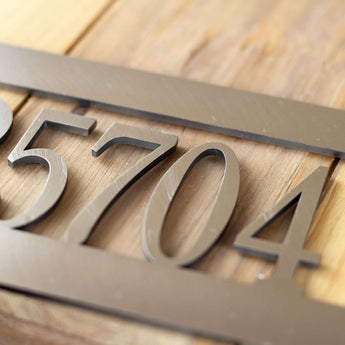 Close up of raw steel on our address metal sign.