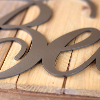 Close up of raw steel on Believe metal sign. 