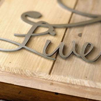 Close up of raw steel on our Live Laugh Love metal sign with birds and heart.