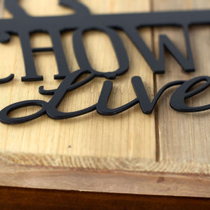 Close up of matte black powder coat on our Chow Chows Live Here metal sign. 