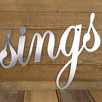 Close up of Blessings metal sign with a script font, in raw steel. 