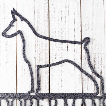 Close up of Doberman silhouette on our metal wall art, in matte black powder coat. 