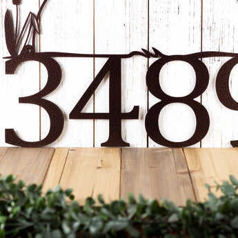 Close up of house number on our heron and cattails metal sign, in copper vein powder coat.