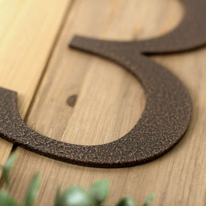 Close up of copper vein powder coat on our metal house number sign.