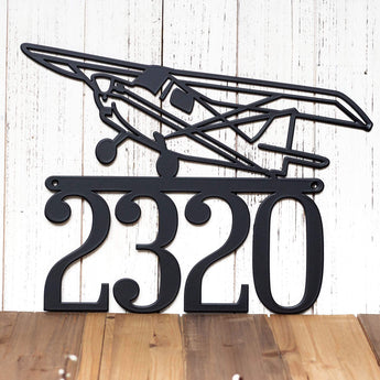 4 digit metal house number plaque with airplane, in matte black powder coat. 