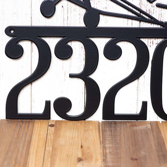 Close up of 4 digit house number on our airplane metal house number sign, in matte black powder coat. 