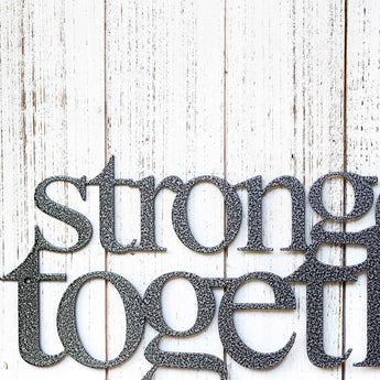 Close up of Stronger Together wording on our metal wall art, in silver vein powder coat.