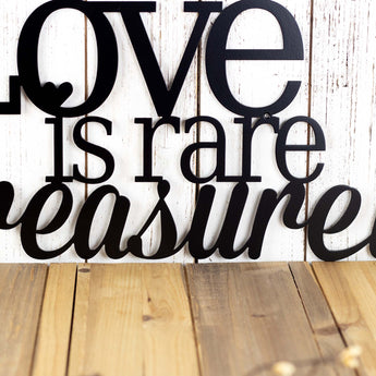 Close up of treasure word on our Love is Rare Treasure It metal wall decor, in matte black powder coat.