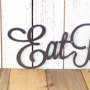 Close up of Eat on our Eat Pray Love metal wall art, in silver vein powder coat. 
