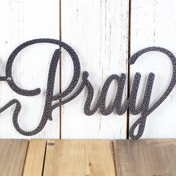Close up of Pray on our Eat Pray Love metal wall art, in silver vein powder coat. 