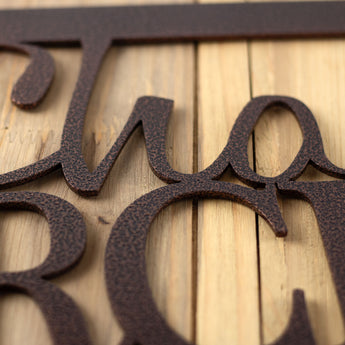 Close up of copper vein powder coat on our hanging orchard metal sign.