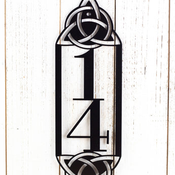 Close up of metal 2 digit vertical house number sign with Celtic knots, in matte black powder coat.