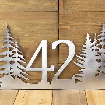 Close up of 2 digit house number on our pine trees metal address sign, in raw steel.