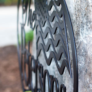 Close up of matte black powder coat on our family name American flag metal sign.