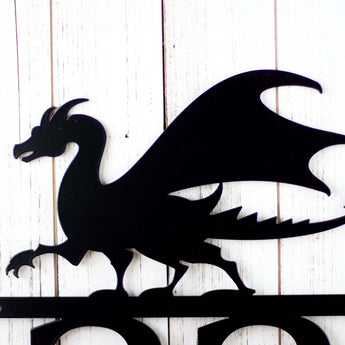 Close up of dragon silhouette on our metal address plaque, in matte black powder coat. 