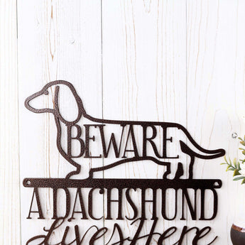 Close up of Dachshund dog silhouette on our Dachshund Lives Here metal sign, in copper vein powder coat.