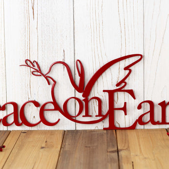 Close up of peace dove on our Peace on Earth metal wall art, in red gloss powder coat.