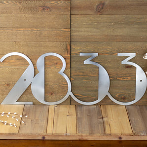4 digit horizontal metal modern house number sign, in raw steel. 