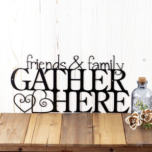Friends & Family Gather Here metal wall art with hearts, in matte black powder coat. 