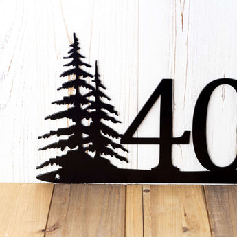Close up of pine trees on our 4 digit metal house number sign, in matte black powder coat. 