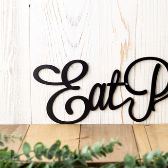Close up of Eat on our Eat Pray Love metal wall decor, in matte black powder coat. 