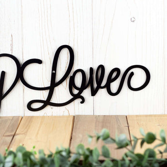Close up of Love on our Eat Pray Love metal sign, in matte black powder coat. 