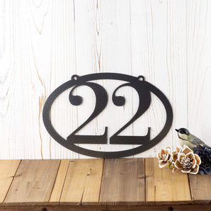 Horizontal oval 2 digit metal house number sign, in silver vein powder coat. 